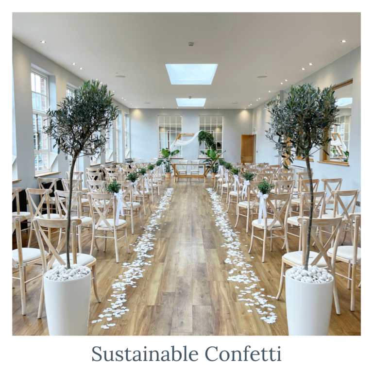 Sustainable white confetti lining a wedding ceremony aisle