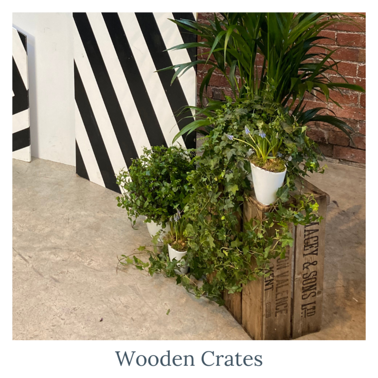 Rustic wooden crates styled with plants for wedding décor