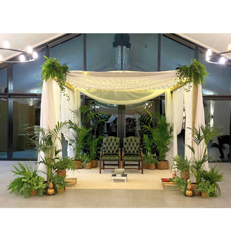 Botanical wedding mandap hire with white draping, fairy lights and lush greenery, ready for a Hindu ceremony