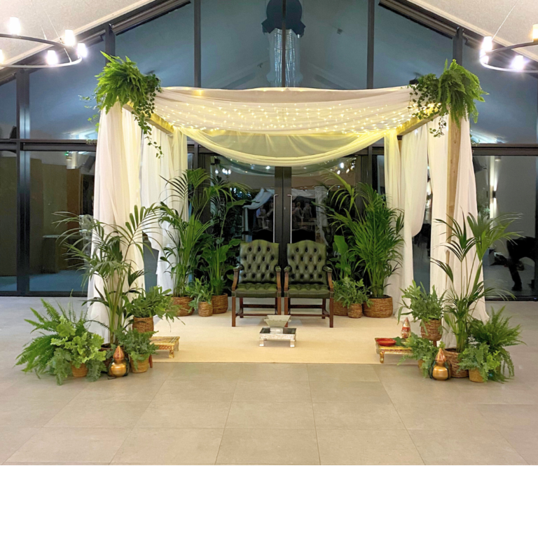 Botanical wedding mandap hire with white draping, fairy lights and lush greenery, ready for a Hindu ceremony